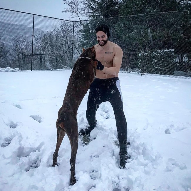 Ekin-Mert-Daymaz-having-fun-with-his-pet-dog-in-February-2019